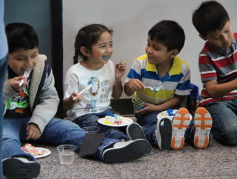 Young children eating cake