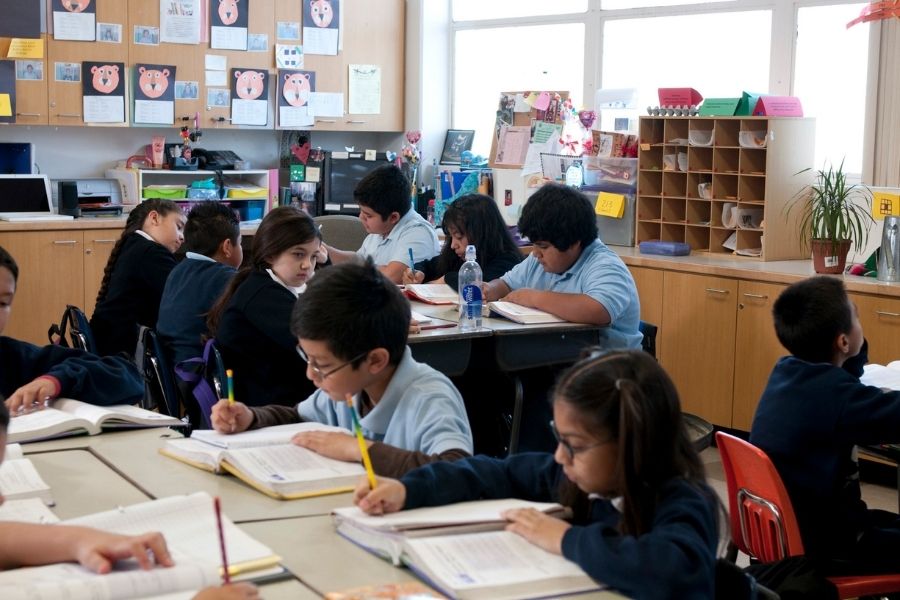 Students in a classroom doing their school work.