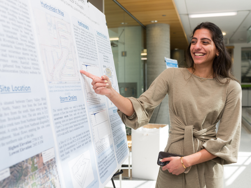 Student explaining her poster