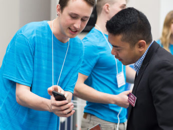 Two people discussing a mobile application