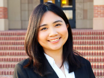 Young female student smiling outside