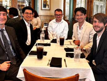 Group of students sitting at restaurant table.