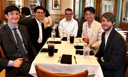 Group of students sitting at restaurant table.