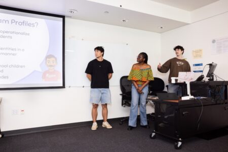 Three students presenting research