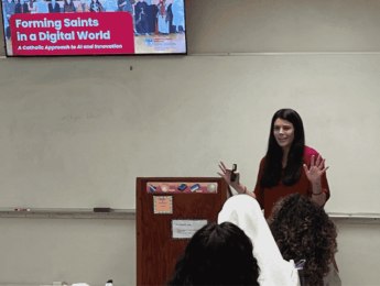 woman giving a talk while standing at a lectern in a classroom