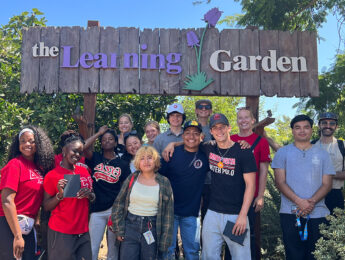Students stand inside the outdoor Learning Garden in Venice.