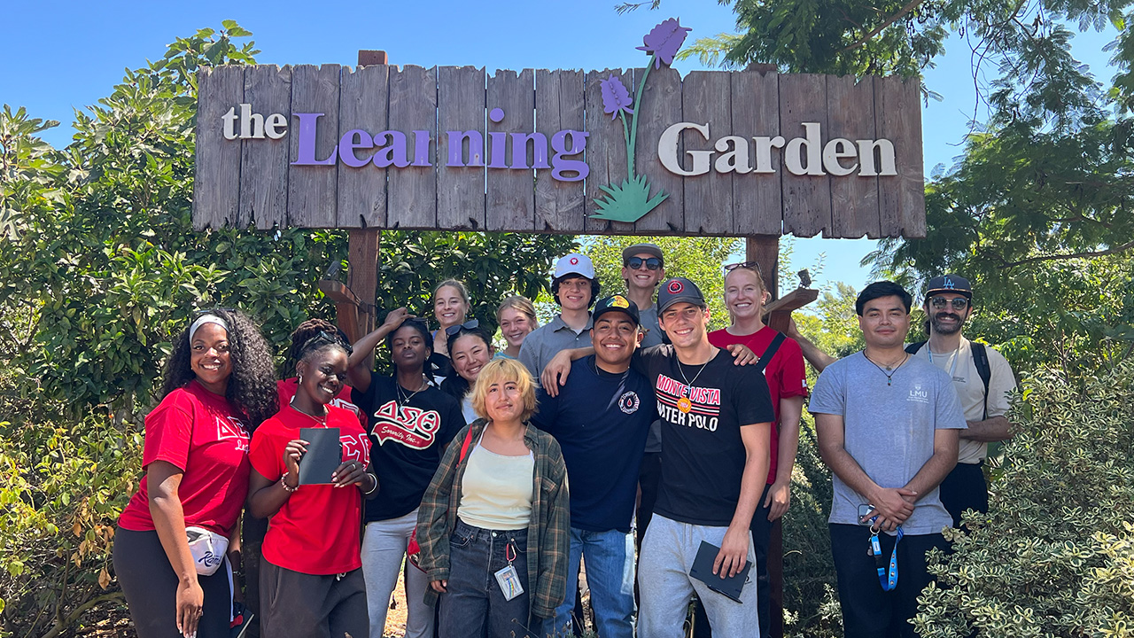Students stand inside the outdoor Learning Garden in Venice.
