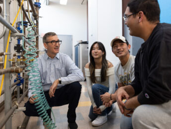 LMU professor discusses in a lab with students