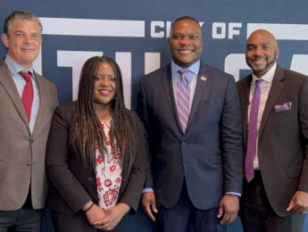 Professor Eric Miller (left) attended Legacy Fest, an event commemorating the anniversary of the Tulsa Race Massacre of 1921, when the $105 million Greenwood Trust for which he advocated was announced.