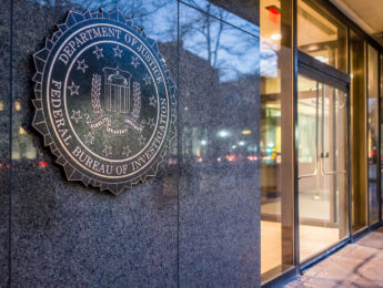 Washington DC, USA - December 29, 2016: FBI, Federal Bureau of Investigation Headquarters, on Pennsylvania avenue sign with traffic reflections at night