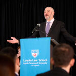 Justin Levitt at podium during LLS Fall Swearing In Ceremony