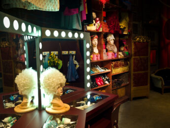 Theater Dressing room with make up mirrors and table, props and costumes.