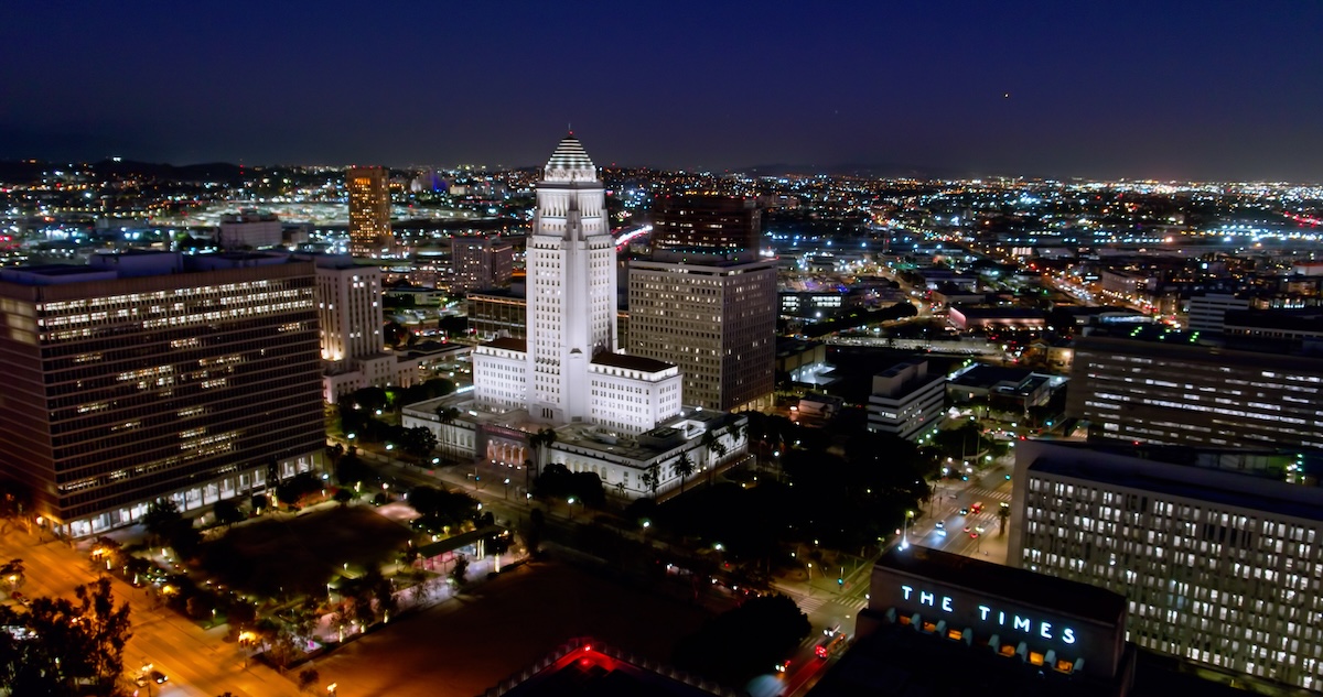 Aerial shot of City Hall and other government buildings in the Civic Center of Downtown Los Angeles (DTLA) at night.