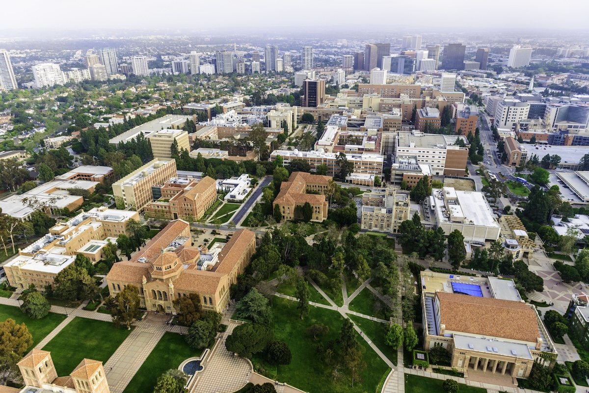 aerial view of campus of University of California in Los Angeles, with smoggy cityscape of Los Angeles, California in the background