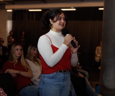 Student Kelsey Rosario talking into a microphone at the Playa Vista Campus