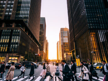 Business people in a city at dusk