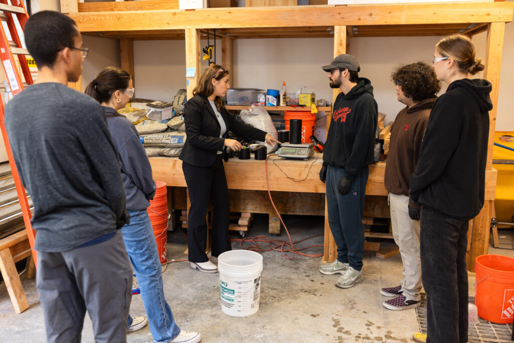 In the concrete lab, Negin Tauberg teaches LMU students how to measure and mix proportions to create different concrete mix designs.