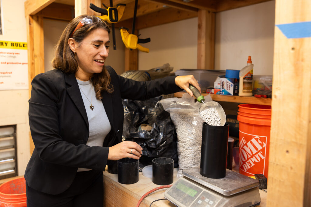 Negin Tauberg mixing concrete to test its strength under earthquake pressure.