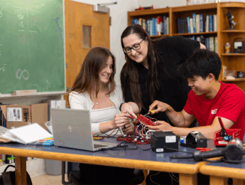 Physics professor Emily Hawkins teaching LMU students in classroom