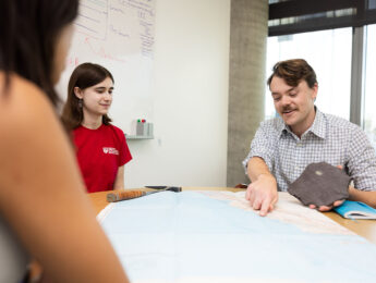 Professor going over map with students