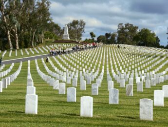US military veterans' headstones stand in rows at the Los Angeles National Cemetery in Westwood, California. Shot on a cloudy spring morning.