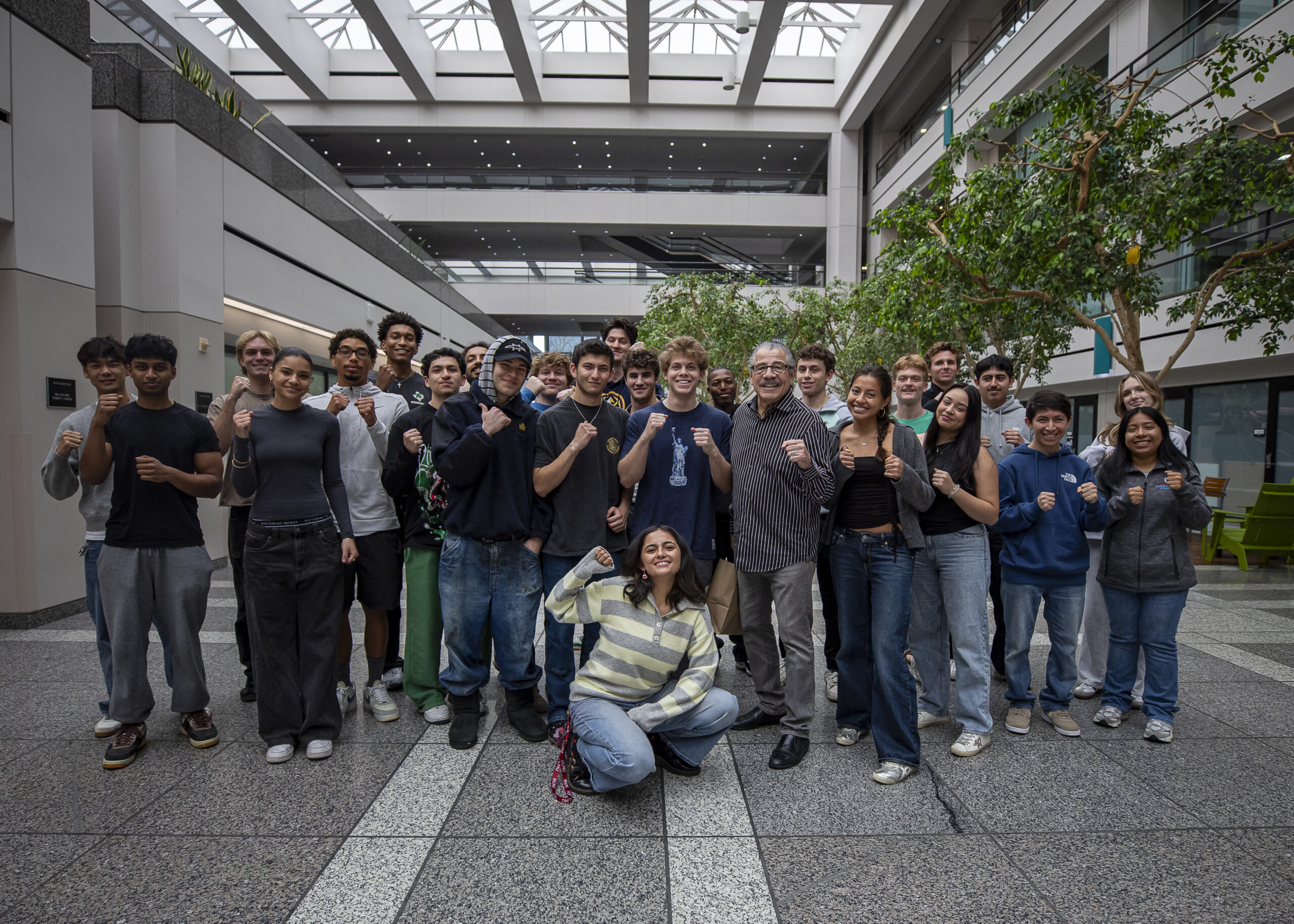 Jacob Stitch Duran with students making boxing poses.