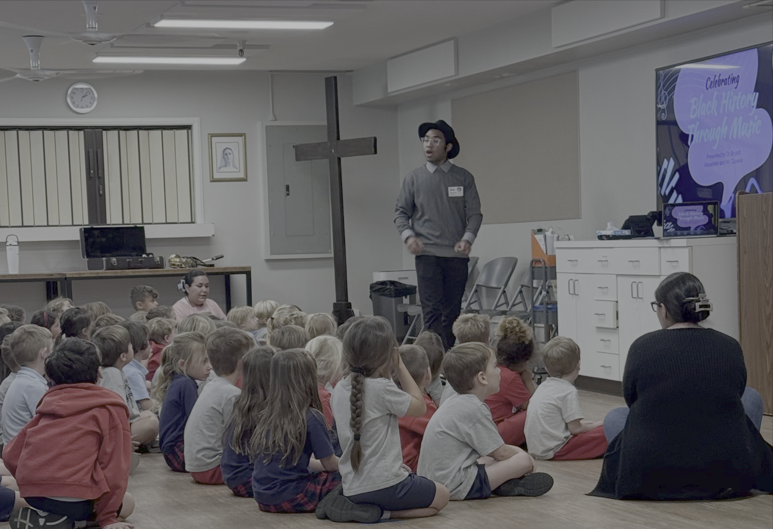 Student teaching in front of a classroom of young kids