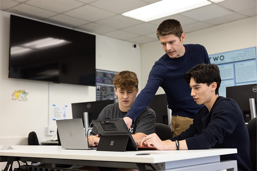 Computer Science professor Jared Coleman teaching students about task scheduling algorithms.