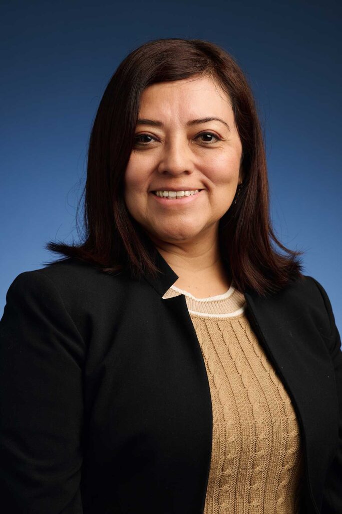 headshot of a woman on a blue background
