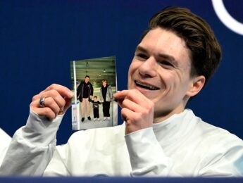 USA's Maxim Naumov holds a picture of his parents, who died in a plane crash last year, after competing in the figure skating men's singles short program during the Milano Cortina 2026 Winter Olympic Games