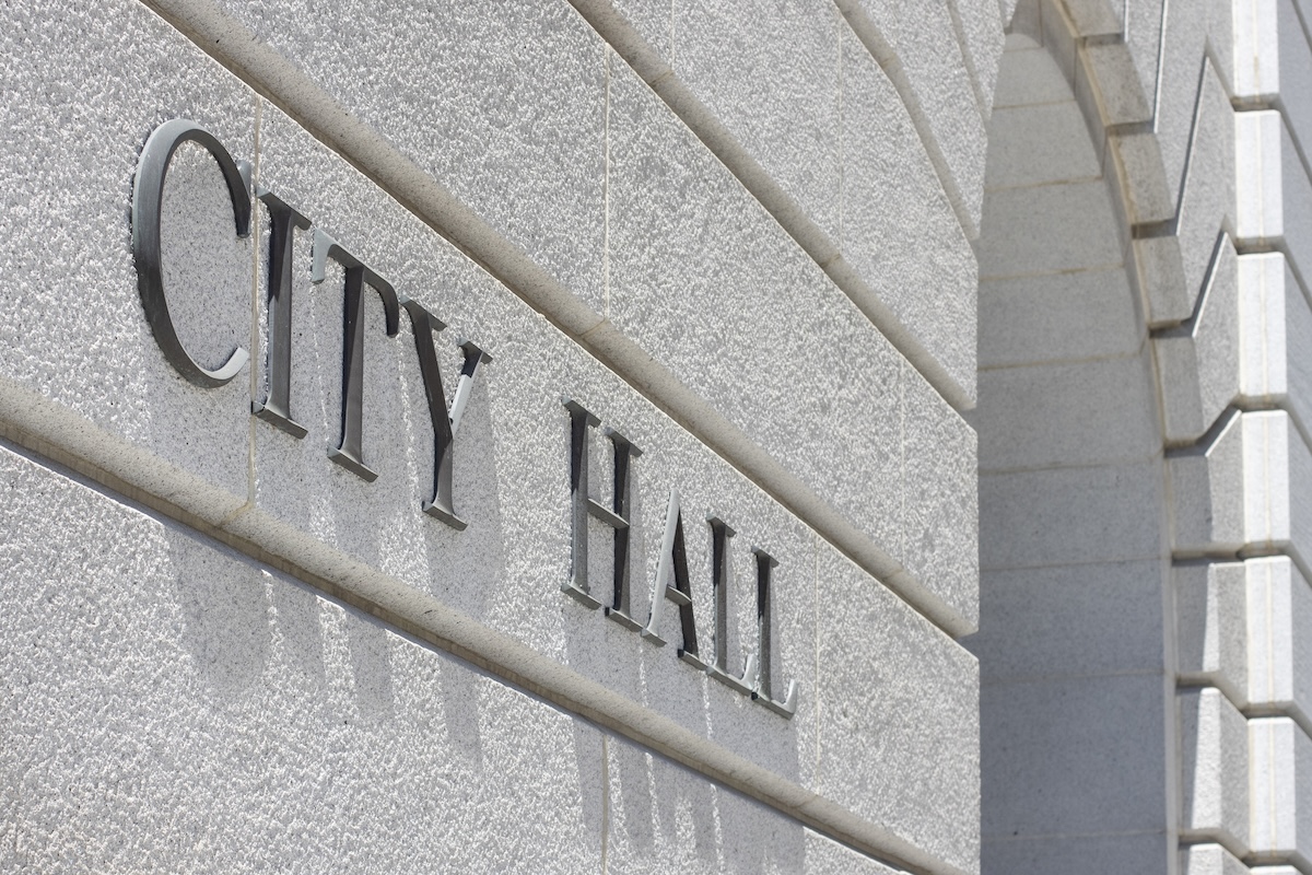 Closeup of the CITY HALL sign seen at one of the entrances to the Los Angeles City Hall in Southern California.