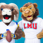 Rampage the mascot for the LA Rams and Iggy the mascot for LMU pose in front of a blue background holding a football