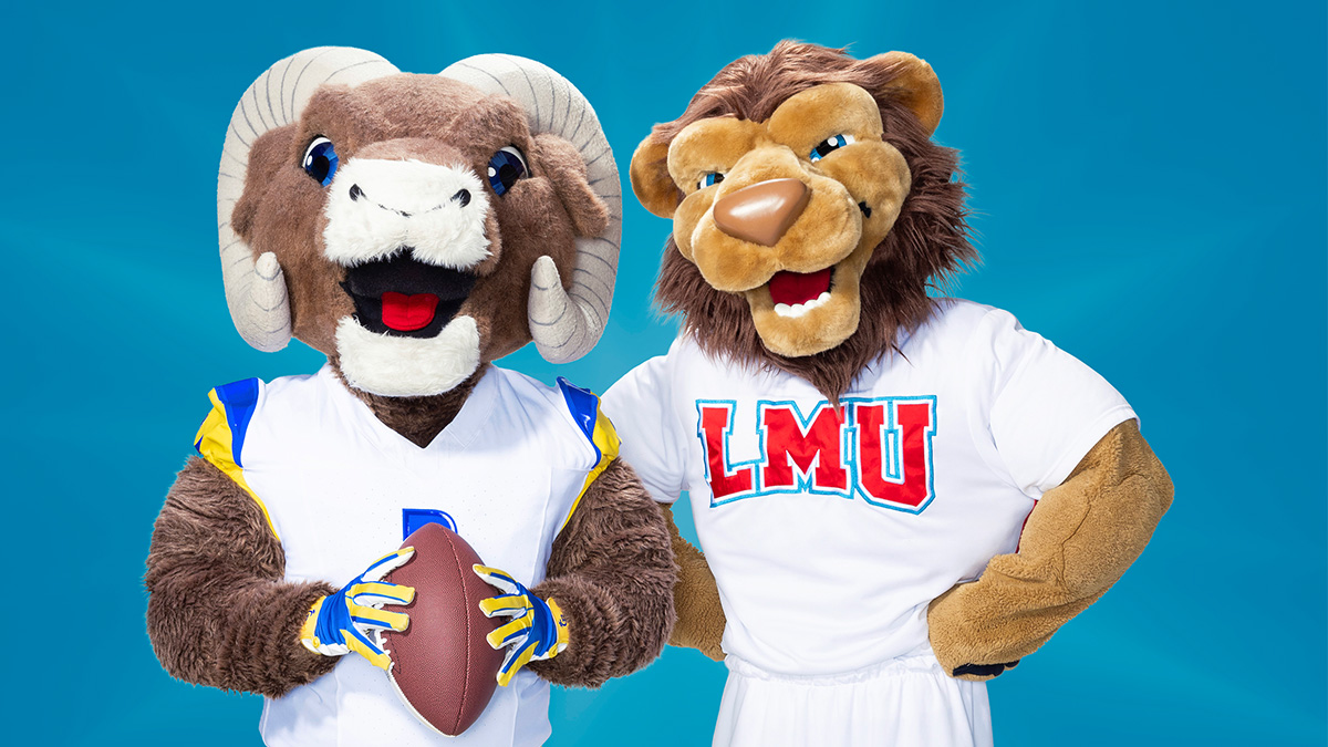 Rampage the mascot for the LA Rams and Iggy the mascot for LMU pose in front of a blue background holding a football