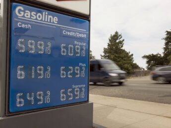 Gas station signage shows the high gasoline prices in CA