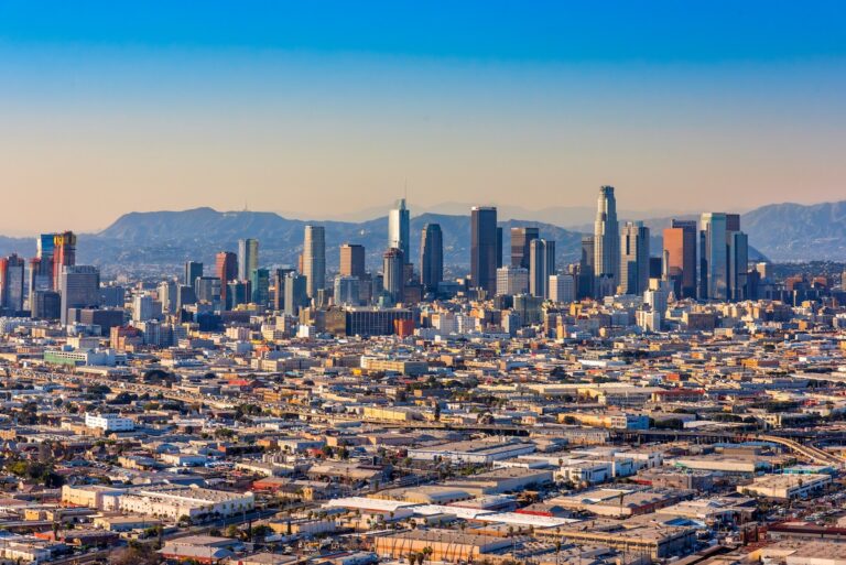 The downtown skyline and surrounding neighborhoods of the city of Los Angeles, California shot via helicopter from an altitude of about 400 feet.