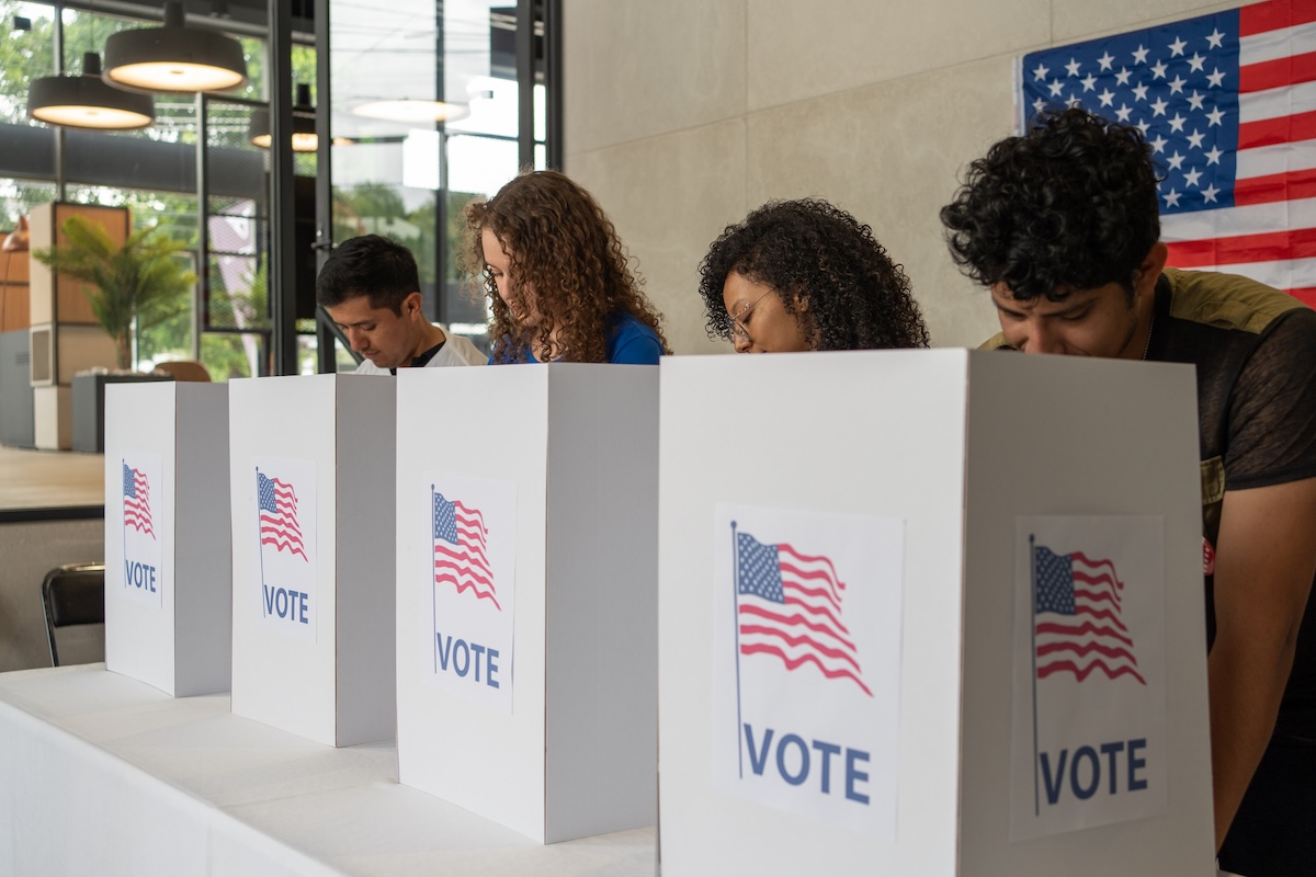 Group of people voting at a polling location