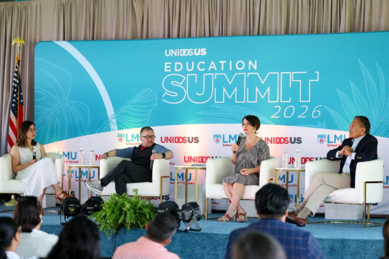 four people sitting on a state with a backdrop behind them of UnidosUS Education Summit