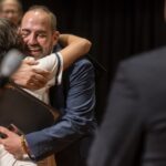 Two people embrace in a hug