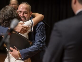 Two people embrace in a hug