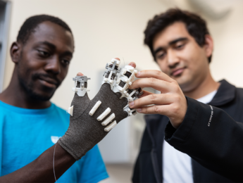Nathaniel Pierre-Louis wearing smart glove with classmate