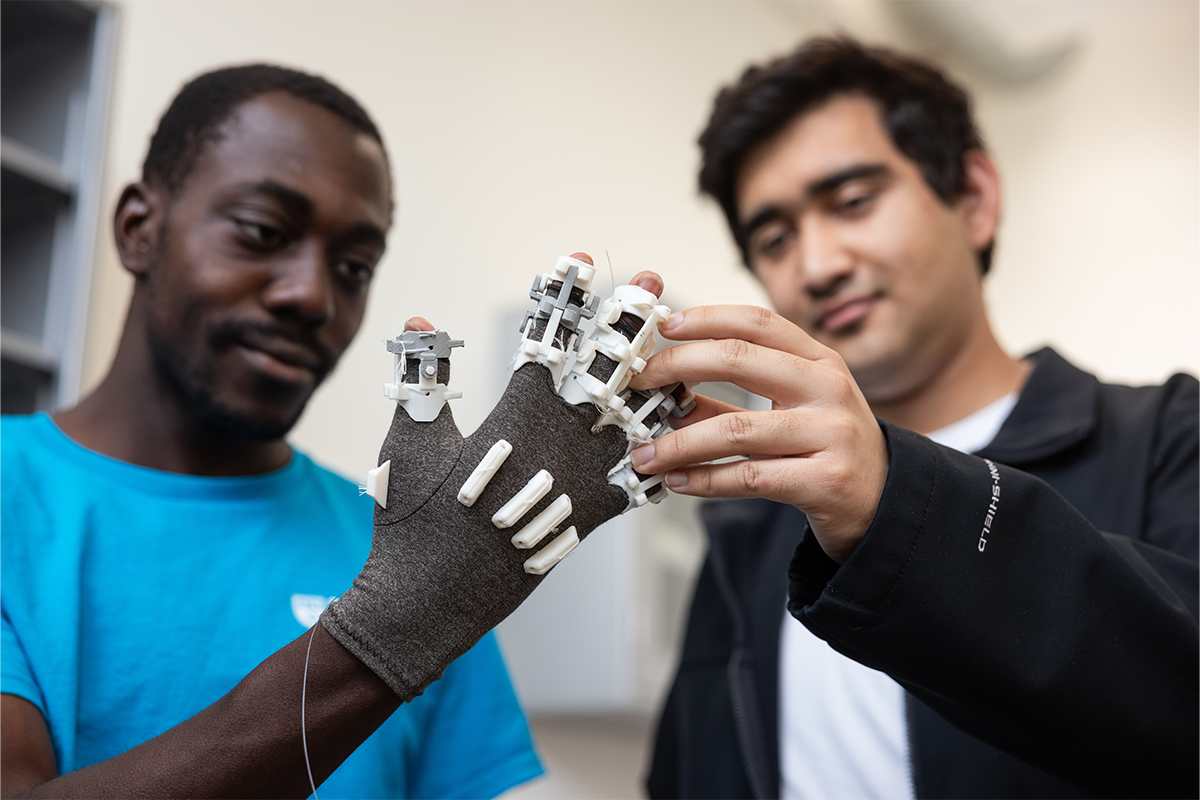 Nathaniel Pierre-Louis wearing smart glove with classmate