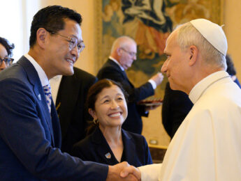 President Poon and Special Ambassador Irwin dressed in a blue greet Pope Leo dressed in all white.
