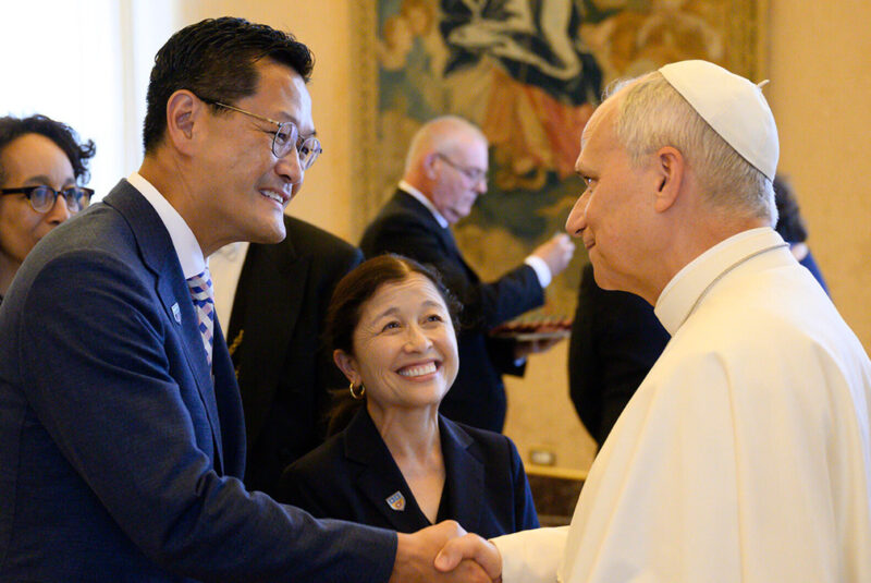 President Poon and Special Ambassador Irwin dressed in a blue greet Pope Leo dressed in all white.