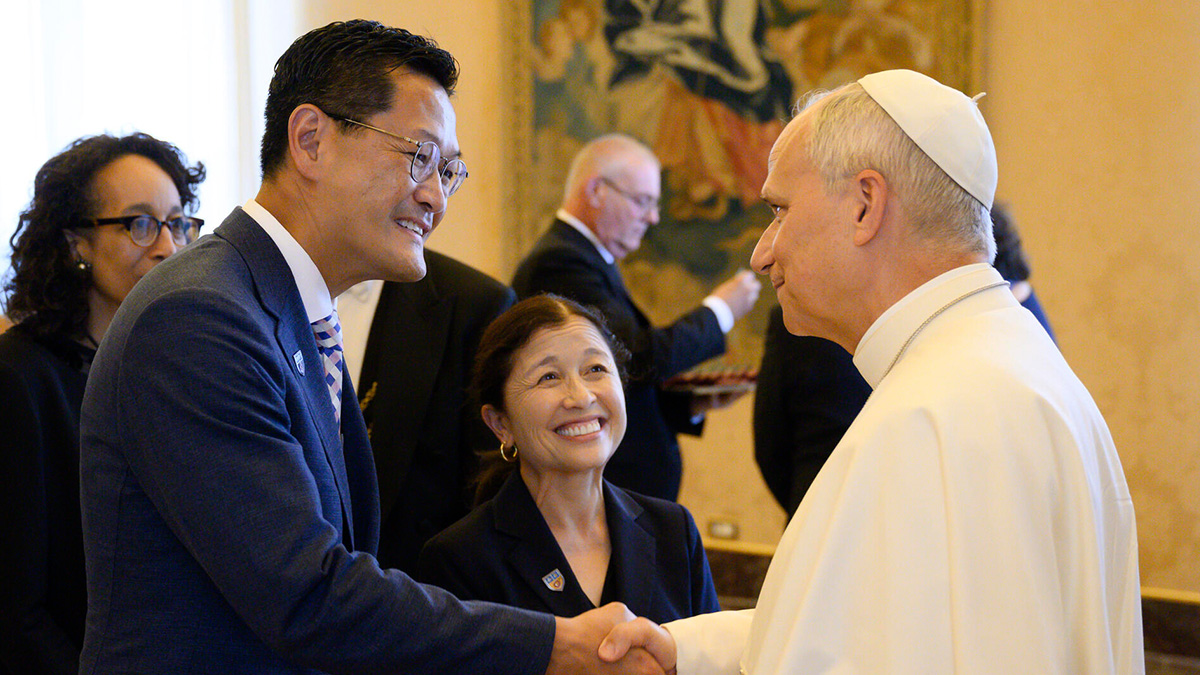 President Poon and Special Ambassador Irwin dressed in a blue greet Pope Leo dressed in all white.