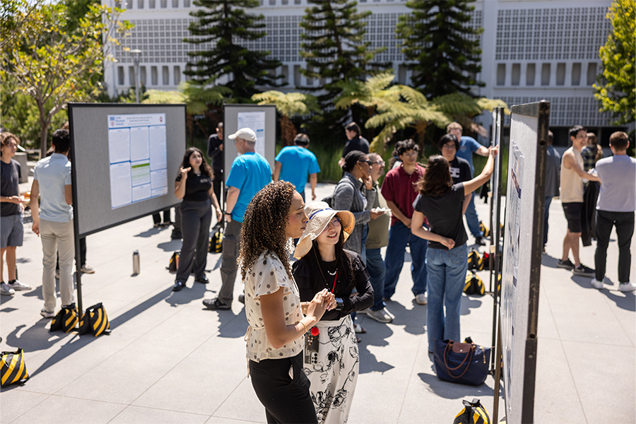 Seaver students standing in front of row of posters outside Life Sciences building