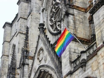 Pride flag flying on the facade of Cathedral Church of St. John the Divine in Morningside Heights, Manhattan, New York City