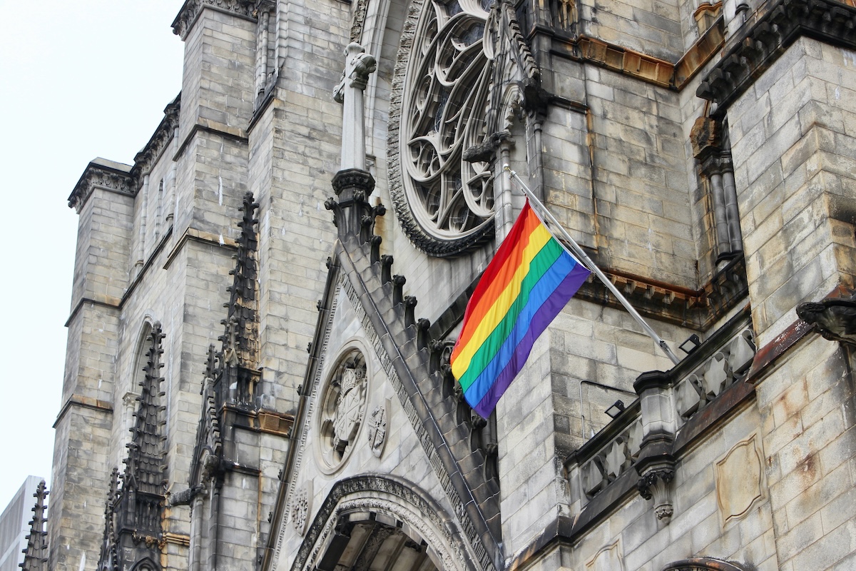 Pride flag flying on the facade of Cathedral Church of St. John the Divine in Morningside Heights, Manhattan, New York City