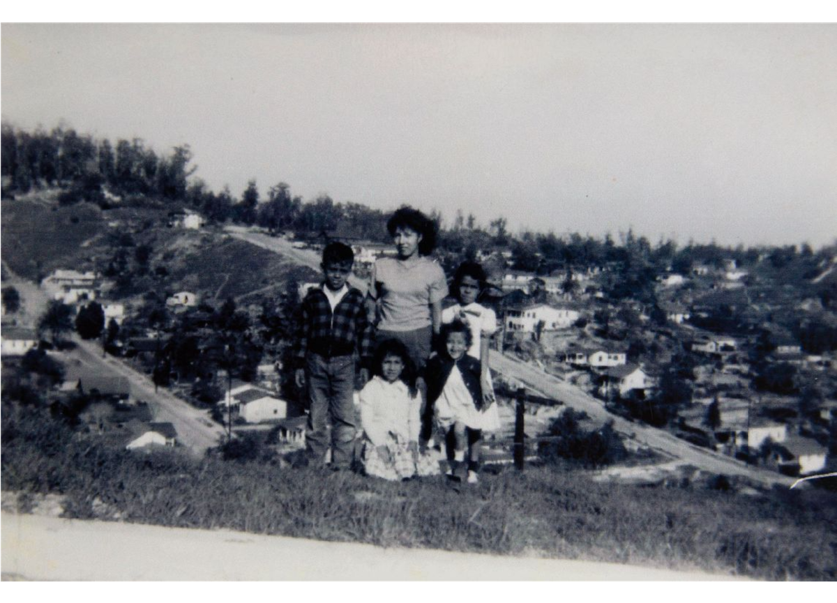 Esther Molano (back center) stands with family members Annie Huitron (back right) and Della Huitron (front right) atop a hill in the Palo Verde neighborhood. The other two children are unidentified. Courtesy Patsy Hinojosa, Chavez Ravine: An Unfinished Story archival collection