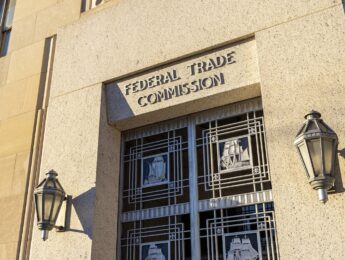 Exterior of the Federal Trade Commission (FTC) building in Washington, D.C., with a door under the sign depicting sailing ships.