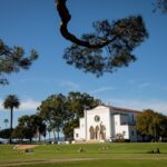 LMU campus with Sacred Heart Chapel framed by tree branches